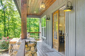 A wooden porch with stone steps, a railing, and a view of a forest. - Fire Pit + Mountain Views! Waynesville Escape (Clyde)