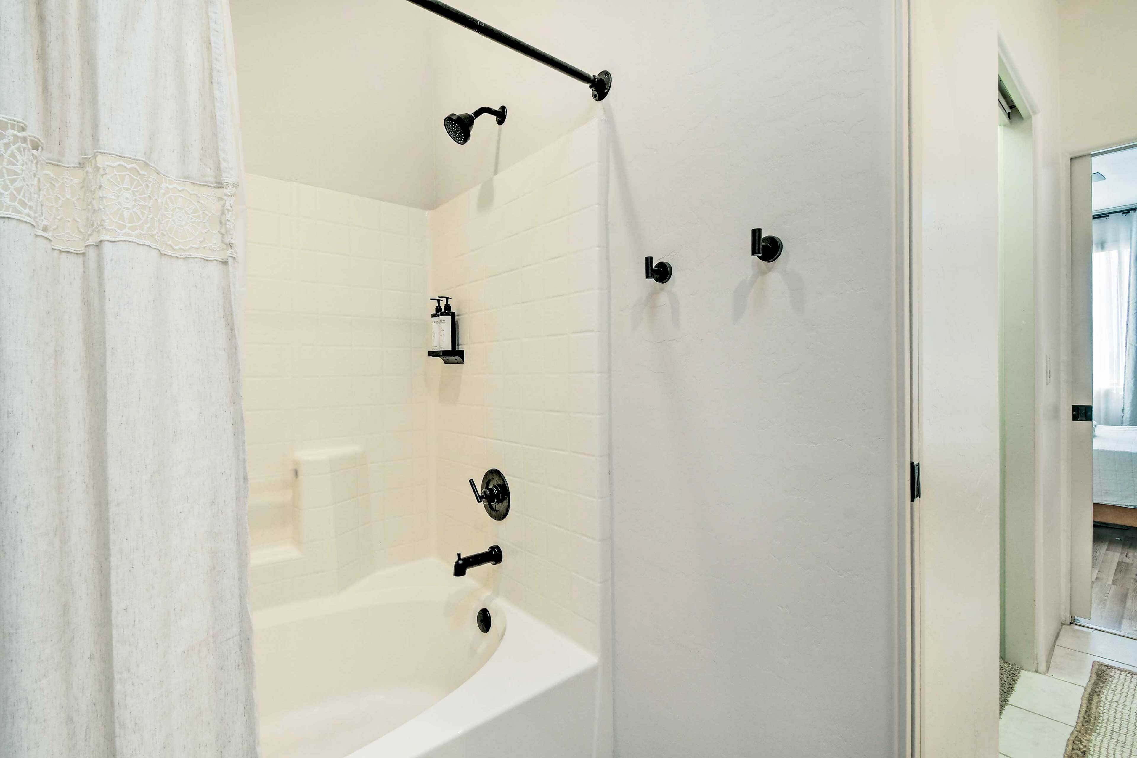 A bathroom with a bathtub, a shower, and a toilet.
