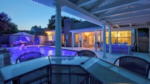 A covered outdoor area with a pool, seating, and string lights. - Walk to Lake! Rowlett Escape w/ Fire Pit & Views (Rowlett)