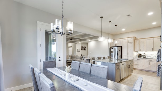 A modern kitchen with a central island, stainless steel appliances, and pendant lighting. - Stunning Grand Junction Home Near Downtown! (Grand Junction)