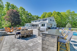 A house with a patio, outdoor seating, and a barbecue area. - Finger Lakes Vacation Rental w/ Hot Tub & Pool (Naples)