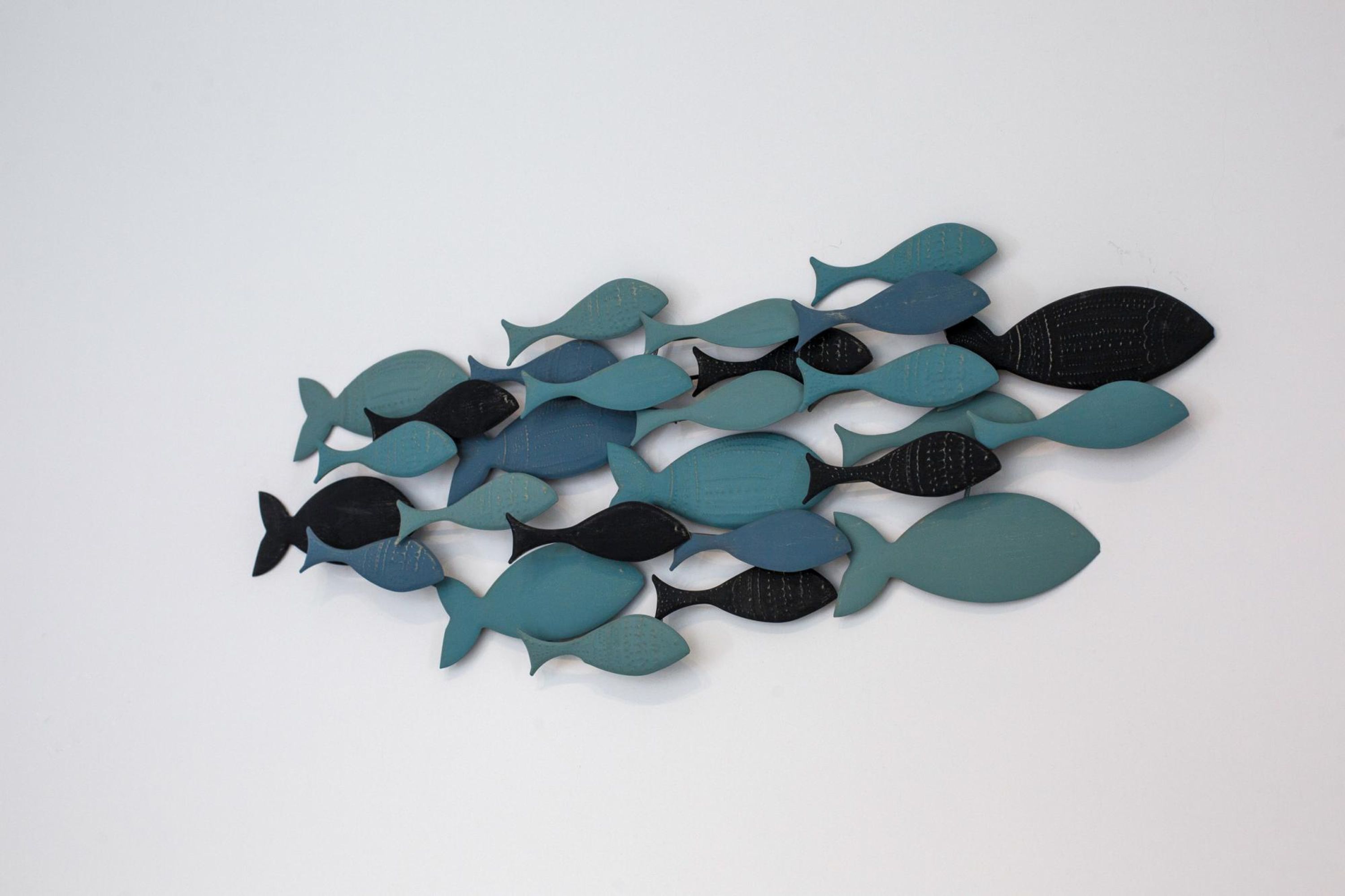 A collection of stylized fish shapes in various sizes and colors.