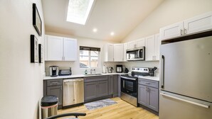 A compact kitchen with white cabinets, a stainless steel refrigerator, a microwave, and a dishwasher. - Modern Pacific Vacation Rental: 5 Mi to Lake Tapps (Pacific)