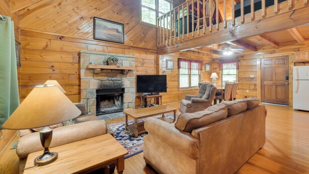 A spacious living room with a fireplace, a television, and a comfortable seating area.