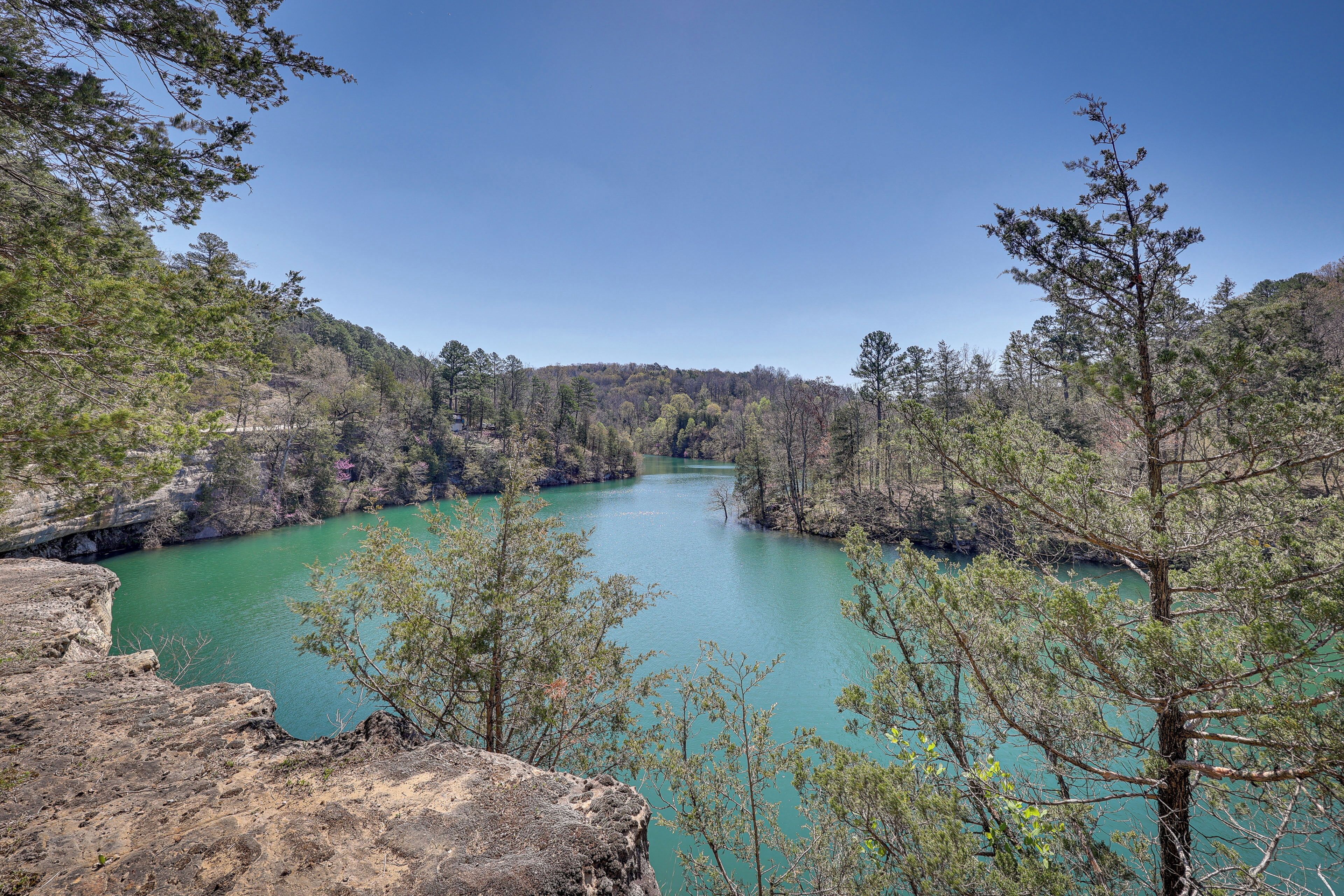 A river surrounded by trees and rocky terrain.
