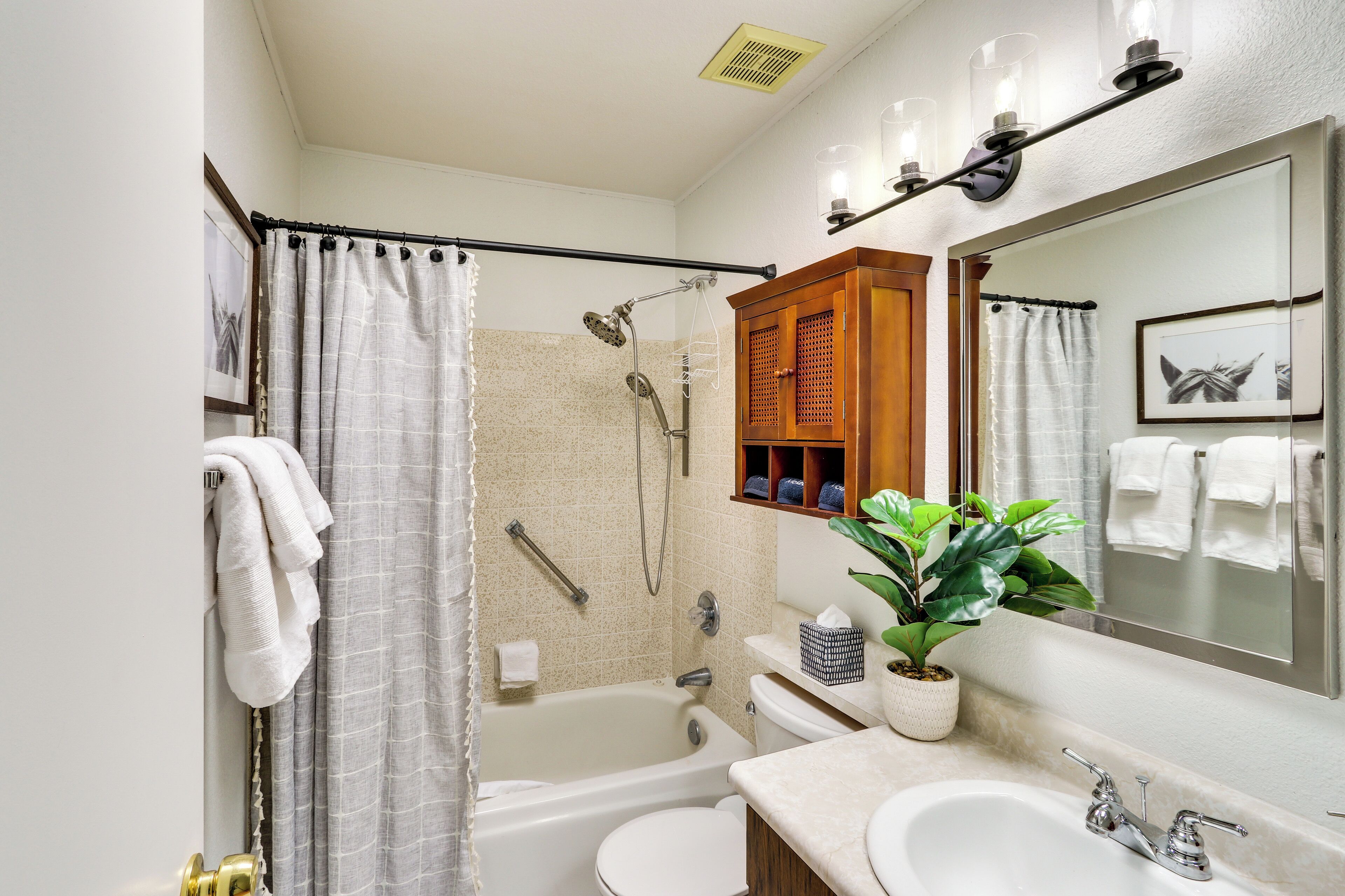 A bathroom with a bathtub, a shower, a toilet, a sink, and a mirror.