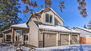 A two-story house with a garage, a covered driveway, and snow on the ground. - Family-friendly Oregon Vacation Home w/ Yard (Bend)
