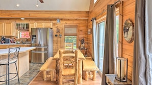 A wooden cabin interior with a kitchen, dining area, and large windows. - Grand Windham Retreat w/ Fire Pit & Game Room (Windham)