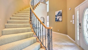 A spiral staircase with carpeted steps and wooden handrails, leading to an upper floor. - Beautiful Montgomery Home w/ Lakefront Deck! (Montgomery)