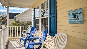 A porch with blue and white chairs, a sign reading "The Hideaway Hut Oak Island," and a white railing. - Oak Island Hideaway Hut ~ 1 Mi to Long Beach! (Oak Island)