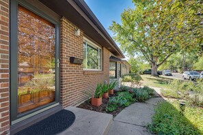 A residential building with a brick facade, large windows, and a well-maintained garden with potted plants. - < 3 Mi to Pearl St: Home w/ Large Yard in Boulder (Boulder)
