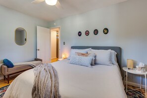 A bedroom with a bed, bedside table, lamp, and a mirror on the wall. - < 3 Mi to Pearl St: Home w/ Large Yard in Boulder (Boulder)