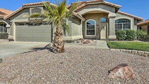 A two-story house with a garage, a palm tree, and a well-maintained lawn. - Private Pool & Fenced Yard: Phoenix Home (Phoenix)