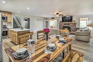 A modern kitchen with wooden cabinets and a built-in microwave.