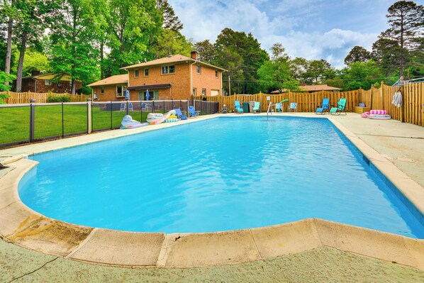 Relax by the pool surrounded by lush greenery and lounge in style.