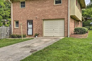 Stunning two-story home with a well-manicured lawn and a garage.