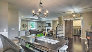 A spacious dining area with a large table, chairs, and a chandelier. - Pinehurst Golf Paradise - 2 Mi to Clubhouse! (Pinehurst)