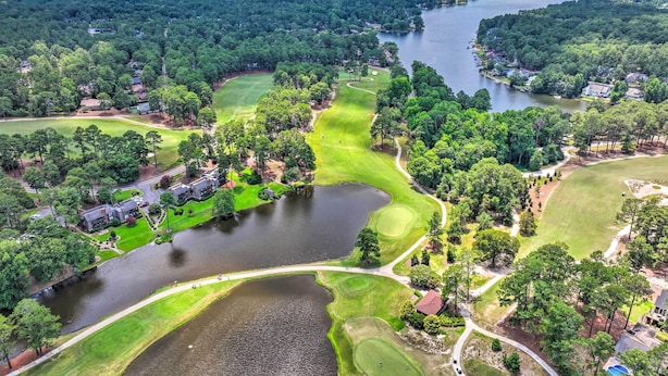 An aerial view of a golf course with a lake, surrounded by dense forests and residential areas. - Pinehurst Golf Paradise - 2 Mi to Clubhouse! (Pinehurst)