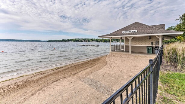 A beachside building named 'Williams Bay' with a covered walkway and a view of the lake. - Breezy-chic Apartment - Steps to Geneva Lake! (Williams Bay)