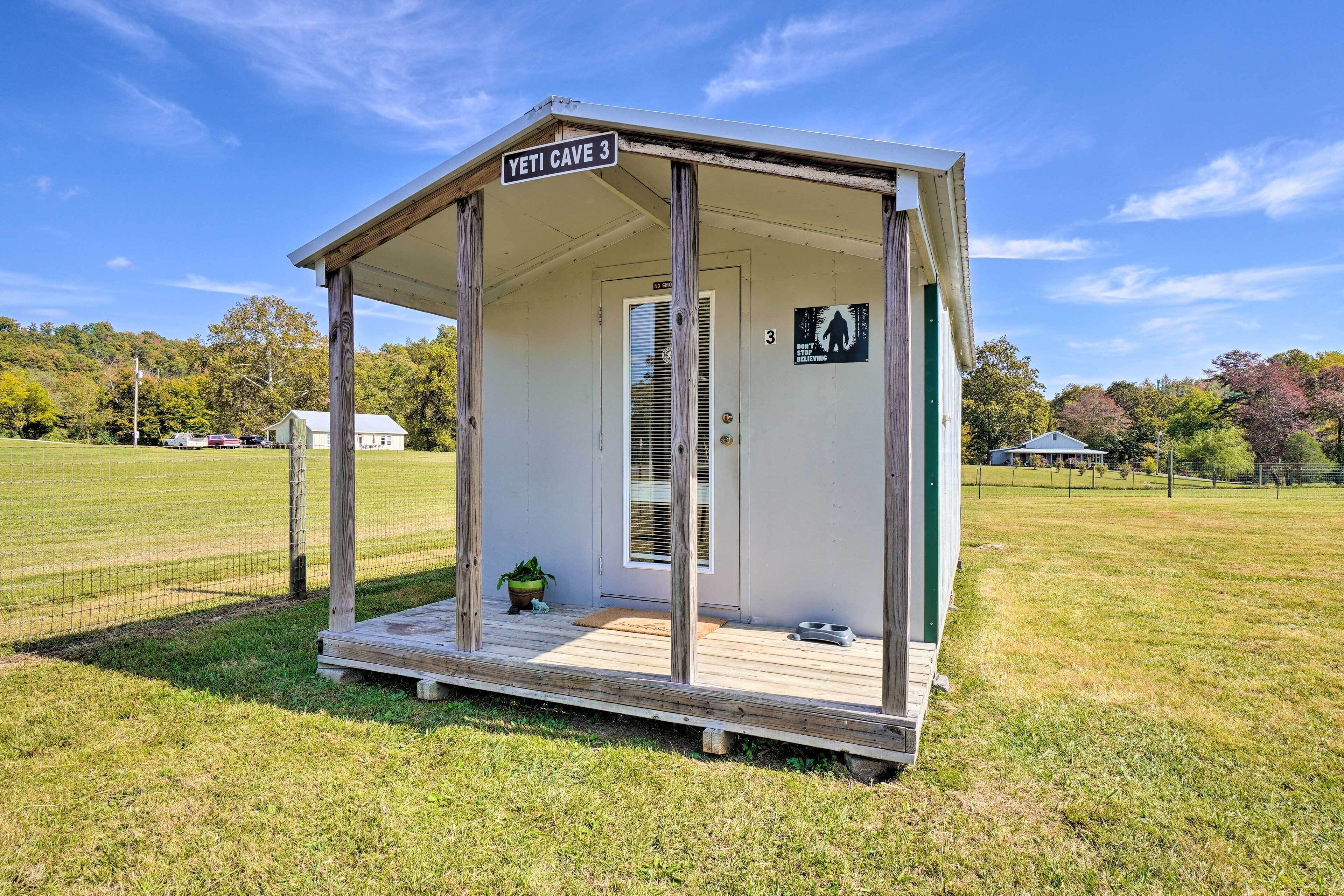 A small, single-room structure labeled "Yeti Cave 3" with a wooden deck and a door.
