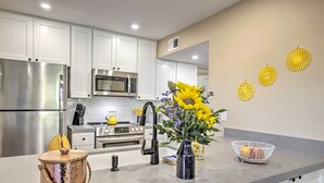 A modern kitchen with stainless steel appliances, white cabinets, and a grey countertop. - Arizona Condo w/ Community Pool & Hot Tub (Mesa)