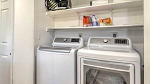 A laundry area with two front-loading washing machines and a dryer. - Arizona Condo w/ Community Pool & Hot Tub (Mesa)