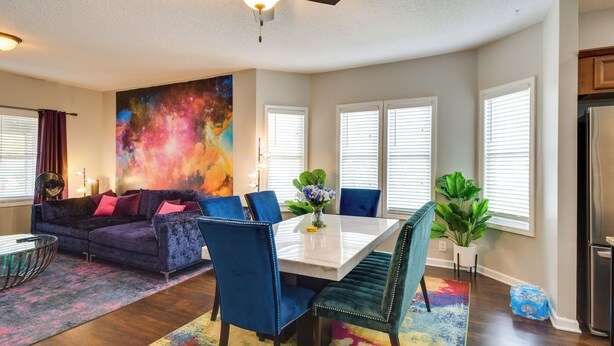 A dining area with a white table, blue chairs, and a ceiling fan. - Pet-friendly Davenport Home - Near Casino & Golf (Davenport)