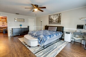 A bedroom with a bed, a desk, a chair, a standing fan, and a radiator. - Lawrenceburg Family Home w/ Seasonal Pool! (Lawrenceburg)
