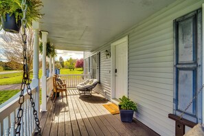 A wooden porch with a white railing, a rocking chair, and a welcome mat. - Dog-friendly Freeville Home ~ 8 Mi Cayuga Lake! (Freeville)