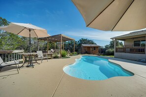A backyard with a swimming pool, outdoor furniture, and a pergola. - New Braunfels Home w/ Pool 2 Mi to Guadalupe River (New Braunfels)