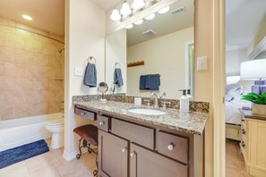 A bathroom with a sink, mirror, and towel rack. - New Braunfels Home w/ Pool 2 Mi to Guadalupe River (New Braunfels)