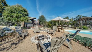 An outdoor patio area with lounge chairs, a fire pit, and a pool. - New Braunfels Home w/ Pool 2 Mi to Guadalupe River (New Braunfels)
