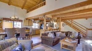A spacious living area with a high ceiling, wooden beams, a dining area, and a kitchen. - Dancing Bear Lodge ~ 1 Mi to Big Bear Lake! (Big Bear Lake)