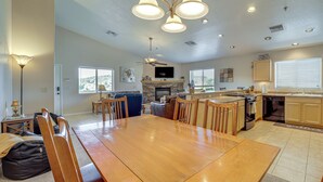 A spacious kitchen with a dining area, wooden furniture, and a fireplace. - 2 Mi to Lake: Apt w/ Balcony in Payson! (Payson)