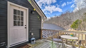 A wooden deck with a door, a welcome mat, and a small table with chairs. - Cozy Lewisburg Getaway w/ Deck + Lake Access! (Lewisburg)