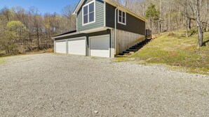 A two-story house with a garage, a front porch, and a driveway leading to the garage. - Cozy Lewisburg Getaway w/ Deck + Lake Access! (Lewisburg)