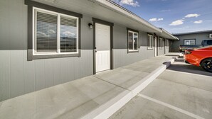 A row of single-story buildings with a concrete walkway leading to the entrance.