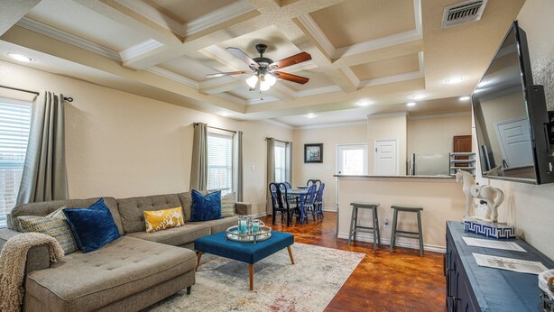 A spacious living room with a sectional sofa, a coffee table, and a dining area with chairs and a table. - San Antonio Townhome ~ 2 Mi to Aquarium! (San Antonio)