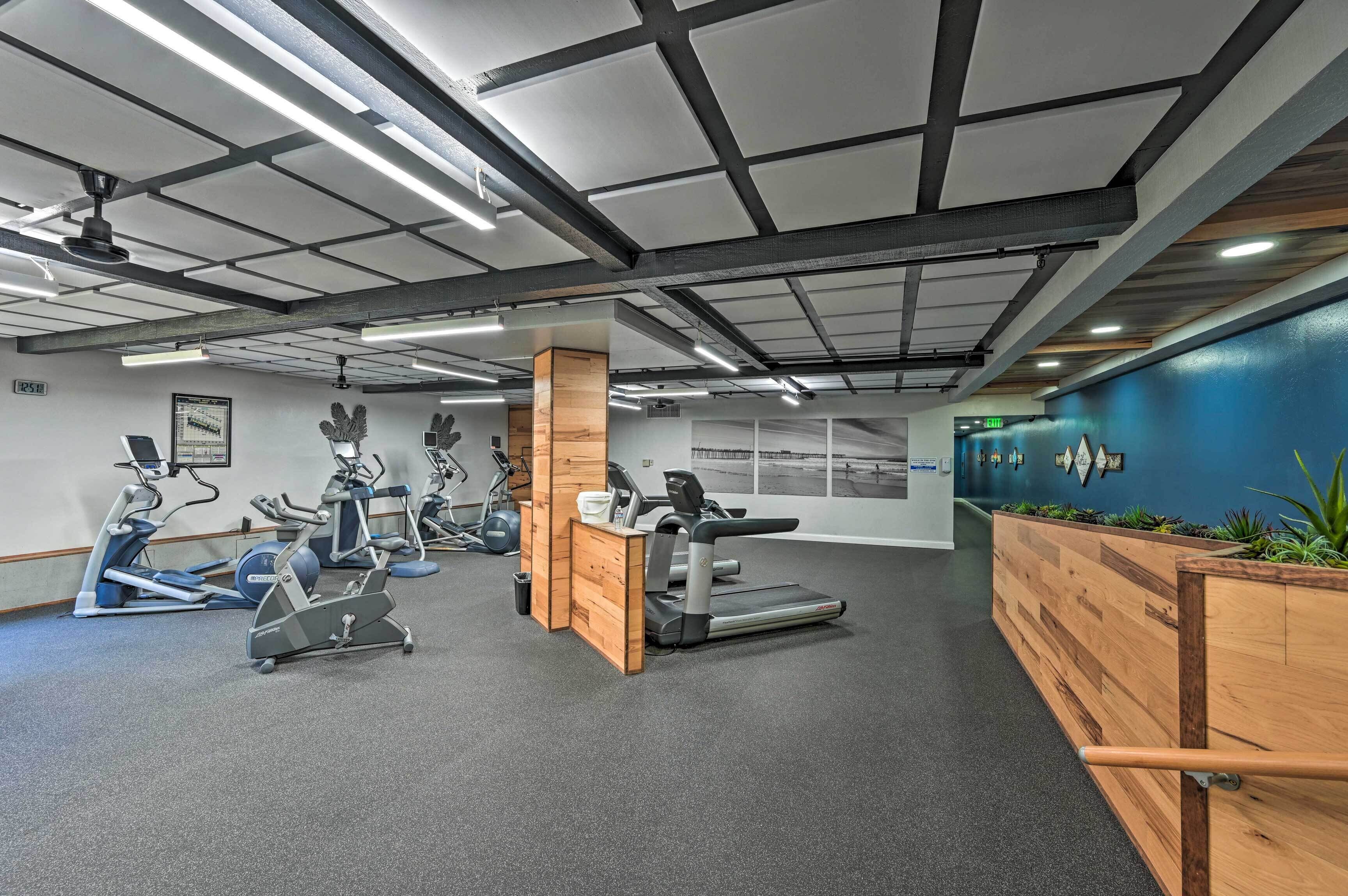 A gym with treadmills, stationary bikes, and exercise equipment.