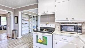 A modern kitchen with white cabinetry, a stainless steel range, a microwave, and a built-in oven. - Charming Gadsden Home w/ Golf Course Views! (Gadsden)