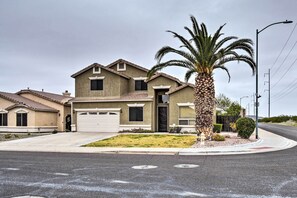 A two-story house with a garage, a palm tree, and a well-maintained lawn. - Phoenix Home: Heated Pool, Patio & Mountain Views! (Phoenix)