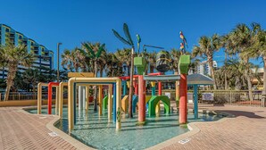 A water play area with colorful structures and palm trees in the background. - Balcony & Resort Amenities at Myrtle Beach Condo! (Myrtle Beach)