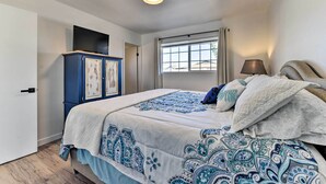 A bedroom with a bed, a wardrobe, a window with curtains, and a ceiling light. - Downtown Gilbert Home w/ Fenced Yard & Fire Pit! (Gilbert)