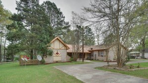 A two-story house with a front yard, a satellite dish, and a small tree. - Hazlehurst Vacation Rental w/ Shared Yard! (Hazlehurst)