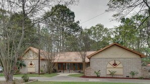 A two-story building with a brick facade, a central entrance, and a small front garden. - Hazlehurst Vacation Rental w/ Shared Yard! (Hazlehurst)