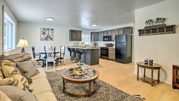 A spacious living room with a sofa, coffee table, and dining area. - Cozy Blackfoot Apartment: Pets Welcome! (Blackfoot)
