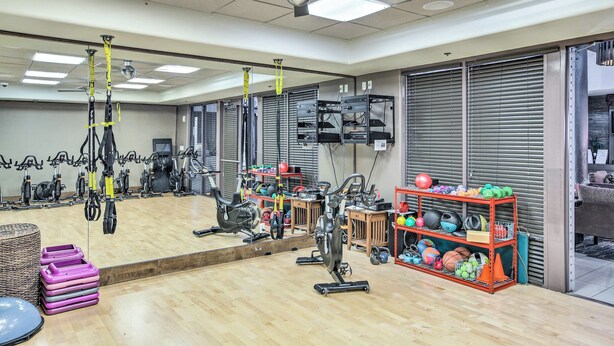 A gym with exercise equipment, a large mirror, and a rack of sports balls. - Pool & Pickleball Access: Quiet Scottsdale Home! (Scottsdale)