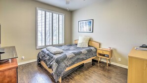 A bedroom with a bed, bedside table, nightstand, and a ceiling fan. - Pool & Pickleball Access: Quiet Scottsdale Home! (Scottsdale)