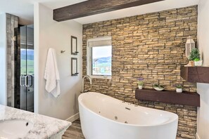 Bathroom features a bathtub and a window with an outdoor view.
