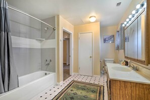 A bathroom with a bathtub, shower, sink, and vanity. - Pet-friendly Duplex - Near Skyline Drive! (Canon City)